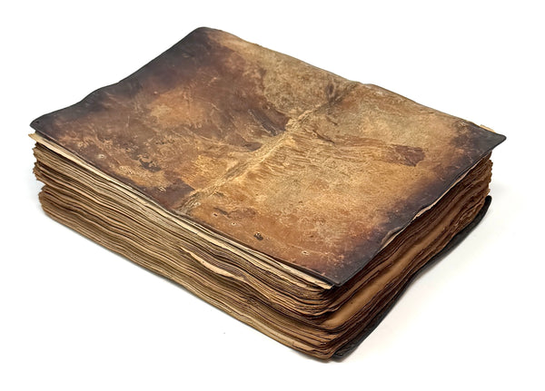 Opposite brown leather cover showing rubbing and surface wear.