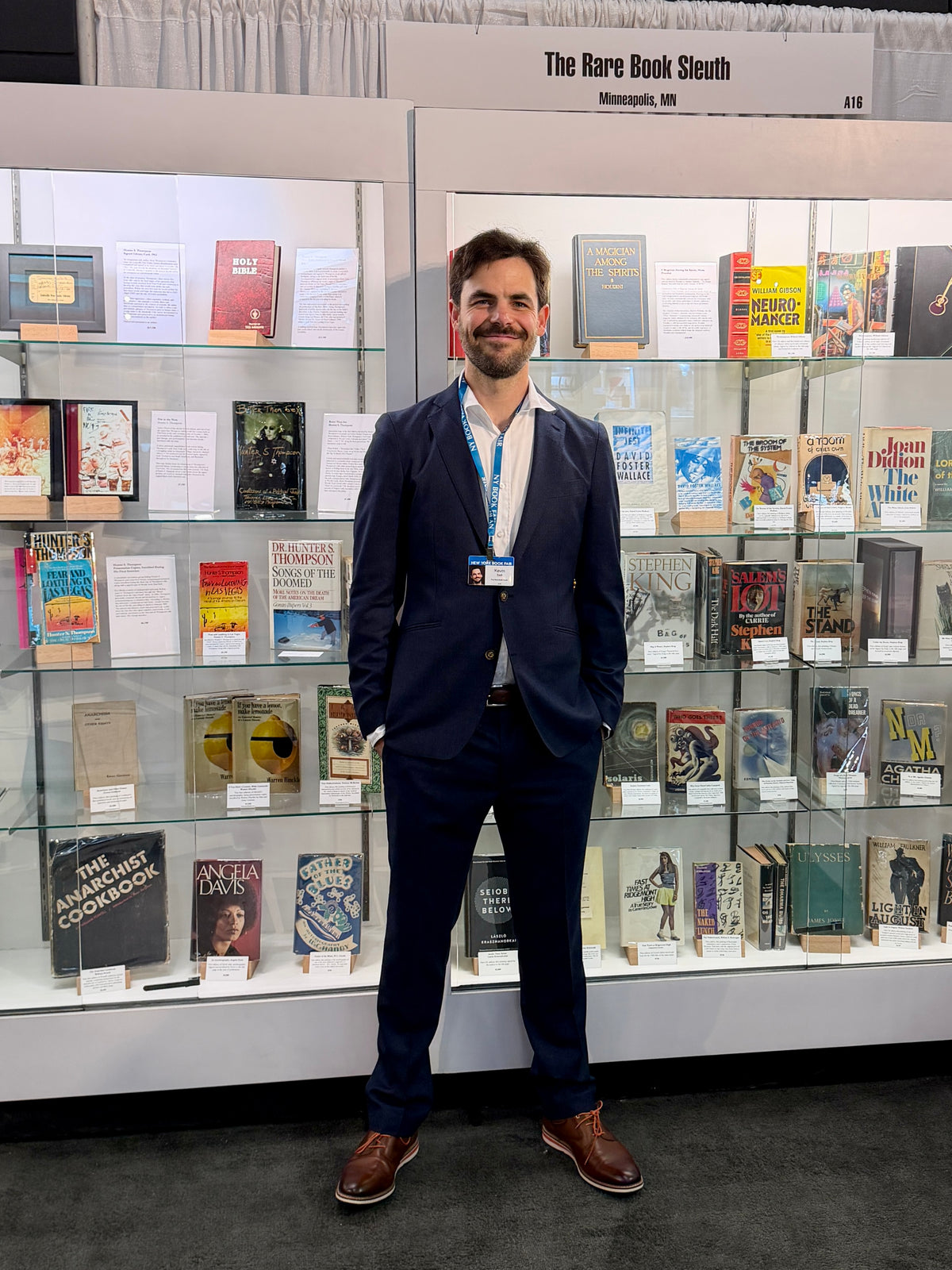 Kevin Sell standing in front of The Rare Book Sleuth’s booth at the New York International Antiquarian Book Fair